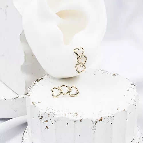 Par de topos mini en rodio three curved hearts